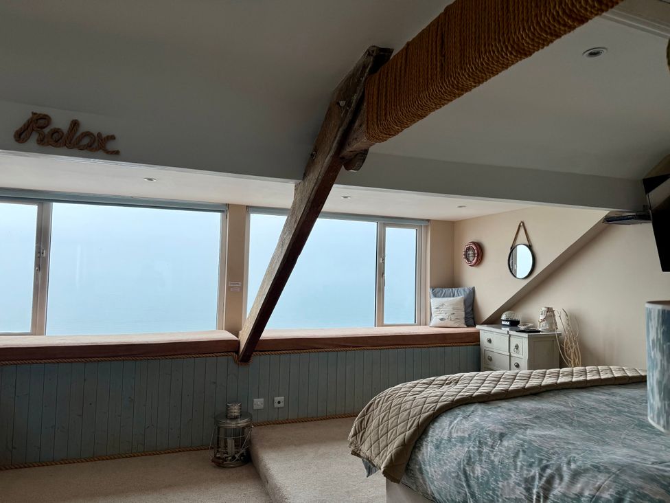 A bedroom with bed and window at The View in Criccieth