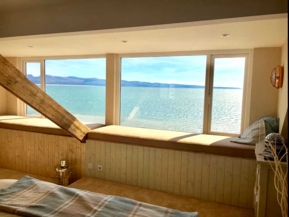 A living room with a sea view and windows at The View in Criccieth