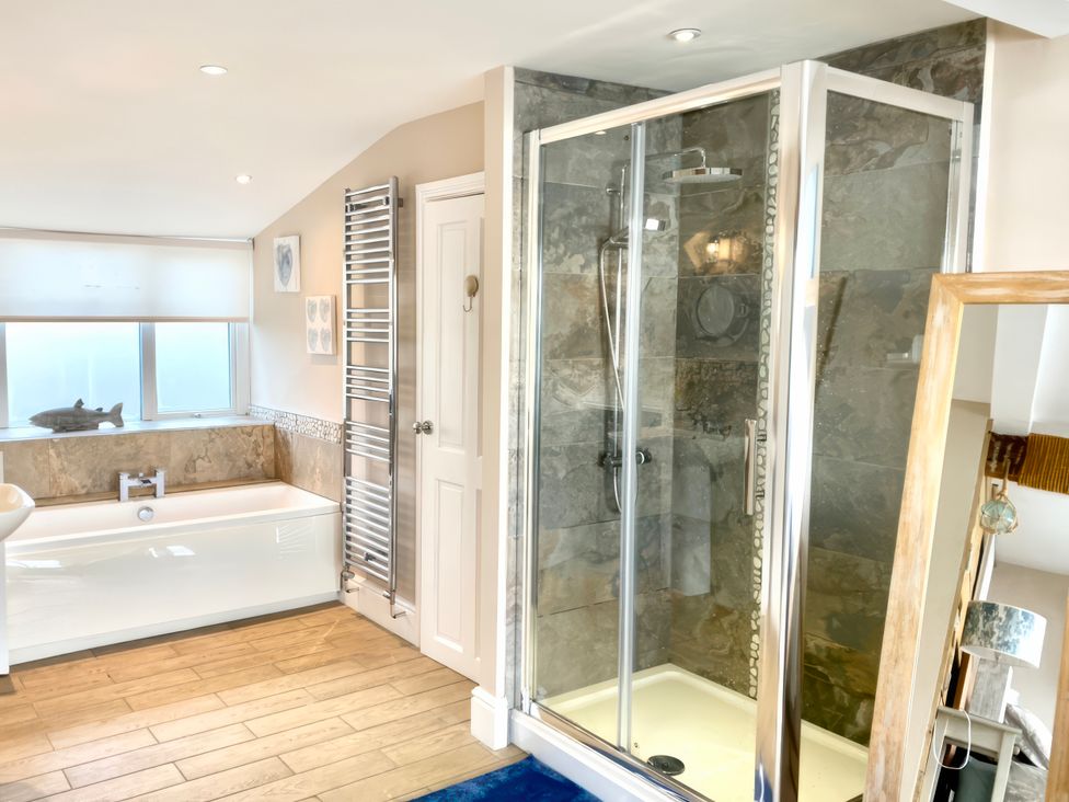 A bathroom with a bathtub and shower at The View in Criccieth