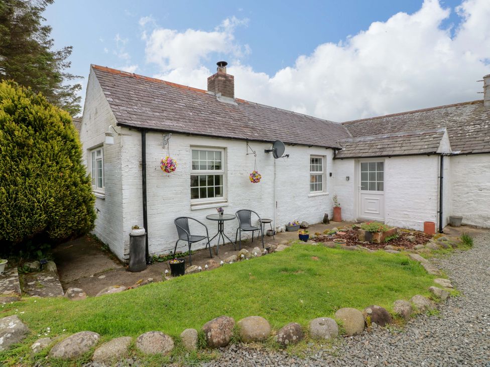 An outdoor area with chairs and table at Camphill Kirkcudbright