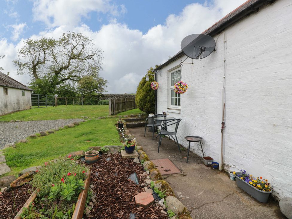 An outdoor seating area with a table and chairs at Camphill in Kirkcudbright