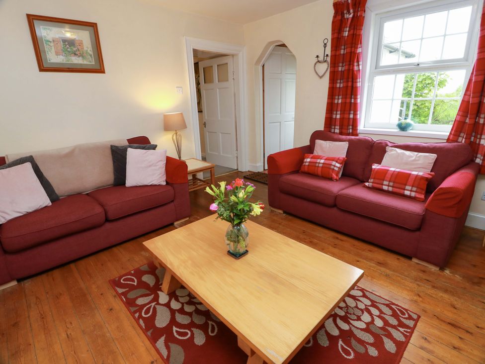 A living room with two sofas and a coffee table at Camphill in Kirkcudbright