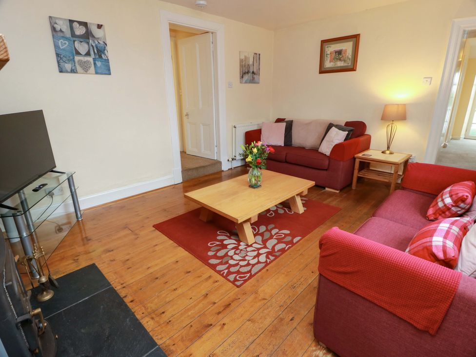 A living room with a coffee table and sofa at Camphill in Kirkcudbright