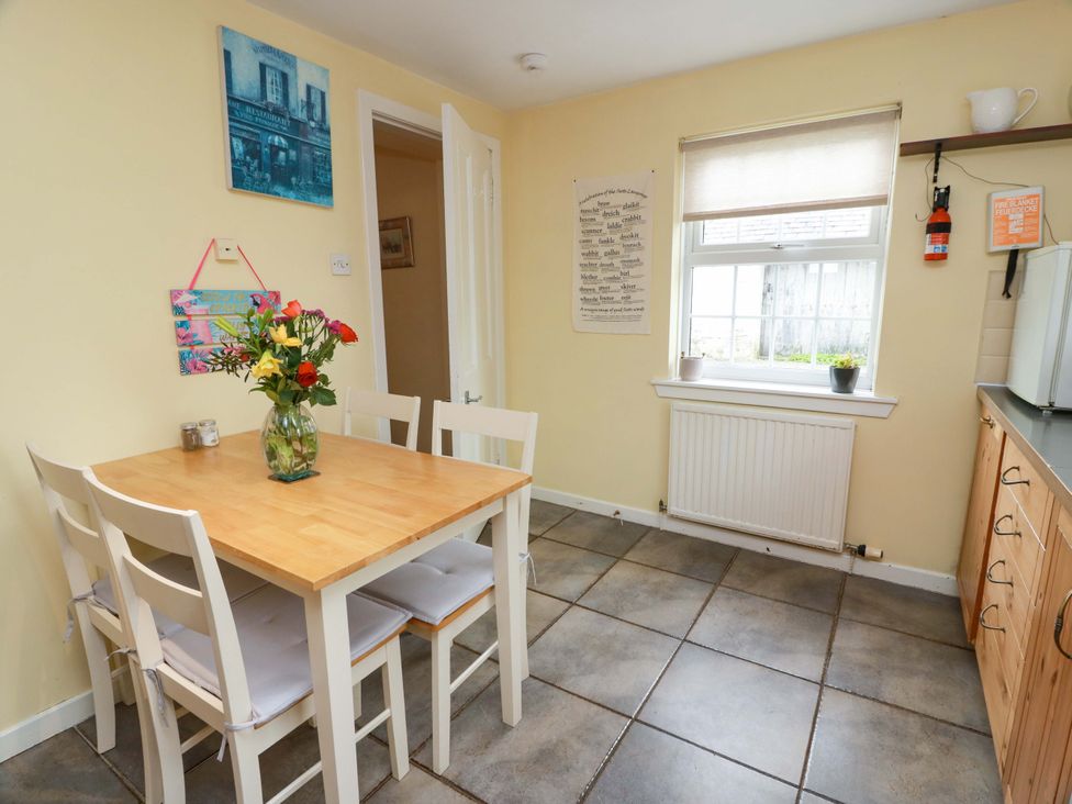 A kitchen with a table and chairs at Camphill in Kirkcudbright