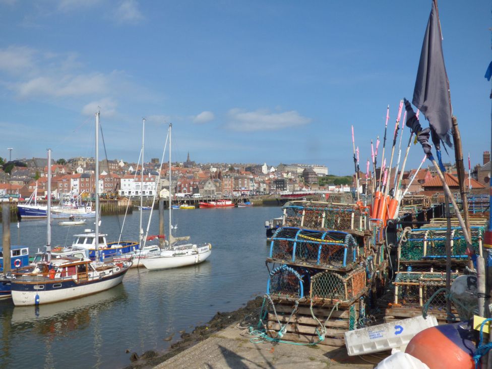 A harbor with boats and fishing traps at Kingfisher in Whitby
