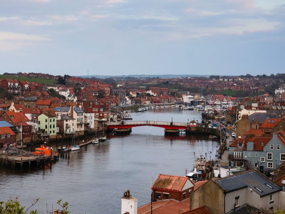 A view of a harbor with houses and a bridge at Kingfisher in Whitby
