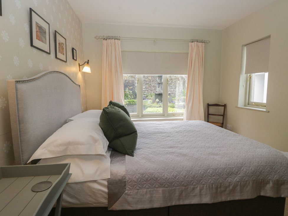 A bedroom with a bed and window at Gable End in Coniston near Hawkshead