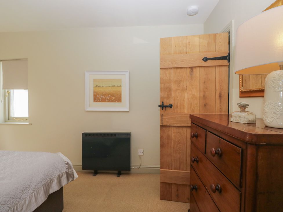 A bedroom with a bed and a wooden drawer at Gable End in Coniston near Hawkshead