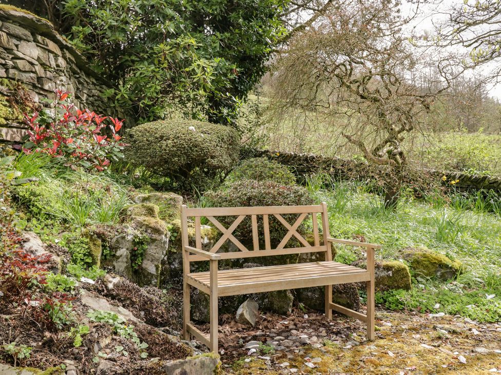 A wooden bench in a garden at Gable End in Coniston near Hawkshead