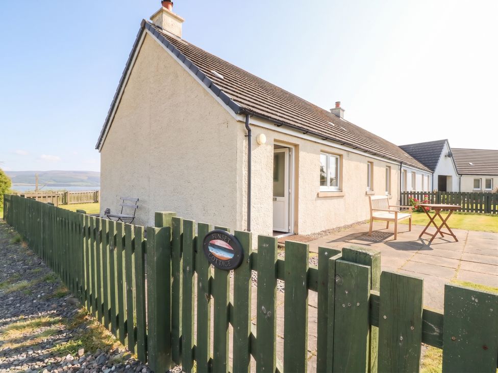 A house exterior with a table and chairs at Sunset Cottage in Craignure, Isle Of Mull