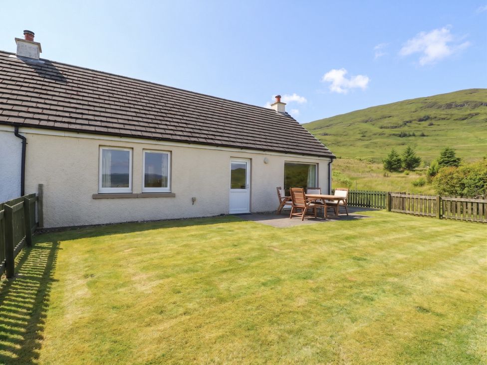 A house with a garden and outdoor seating at Sunset Cottage in Craignure, Isle Of Mull