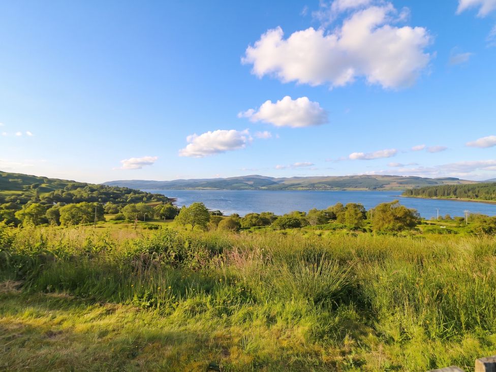 A view of water surrounded by hills and trees at Sunset Cottage, Craignure, Isle Of Mull