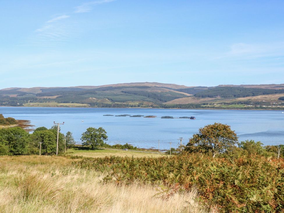 A view of a body of water with hills and trees at Sunset Cottage Craignure, Isle Of Mull