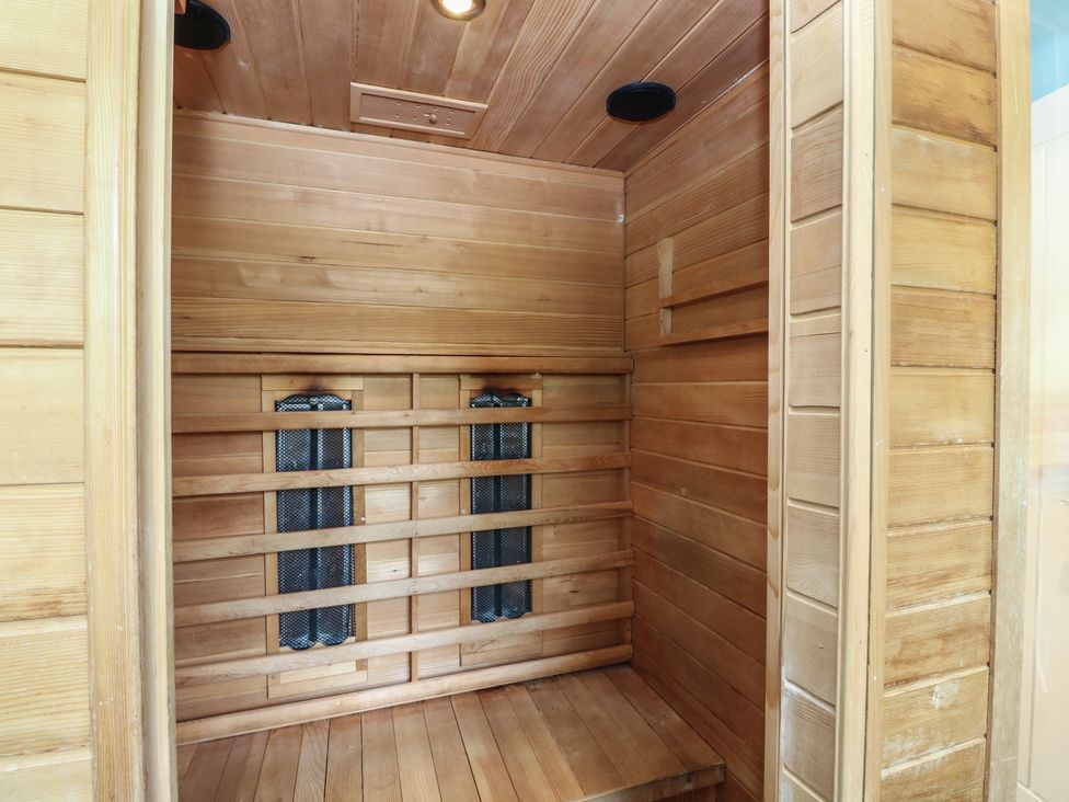 A sauna with wooden panels and heating elements at Starfish Cottage, Craignure, Isle Of Mull