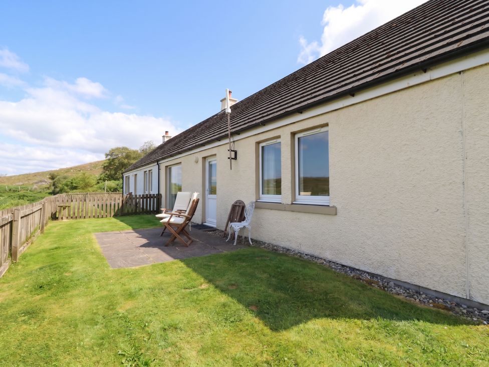 A house with patio and garden chairs at Starfish Cottage in Craignure, Isle Of Mull