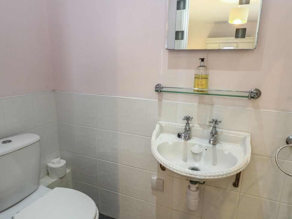 A bathroom with a sink and toilet at Driftwood Cottage, Craignure, Isle Of Mull