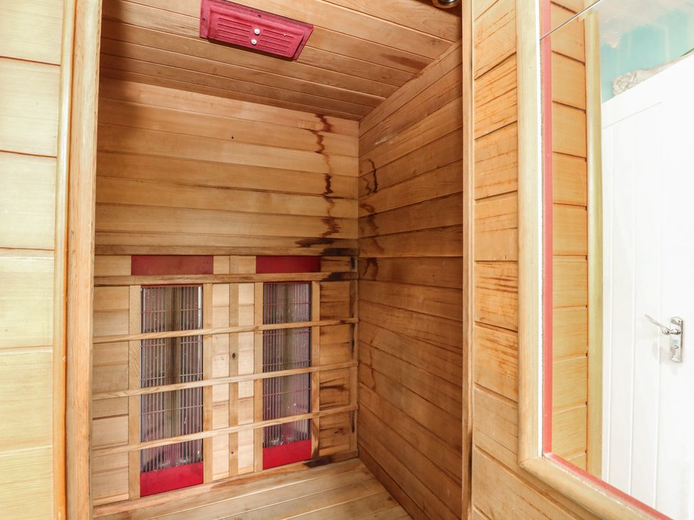 A sauna with wooden paneling and infrared heaters at Poppies Cottage, Craignure, Isle Of Mull