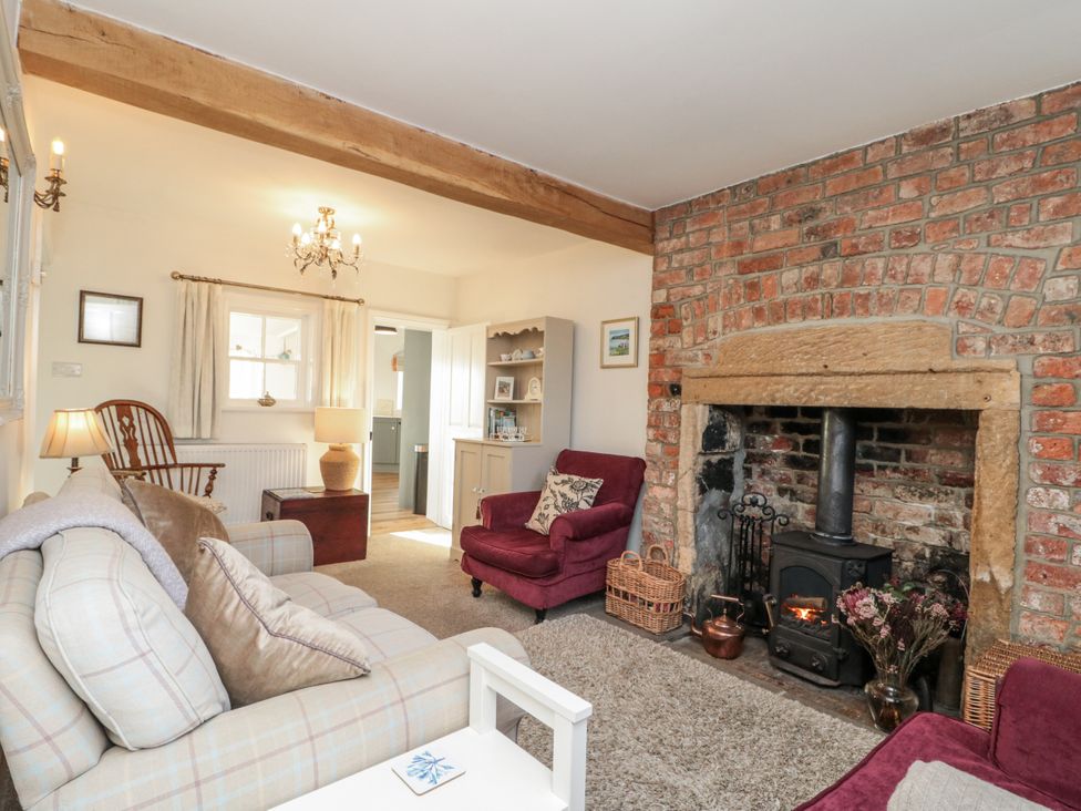 A living room with a fireplace and sofas at Croft View in Fylingthorpe near Robin Hood's Bay