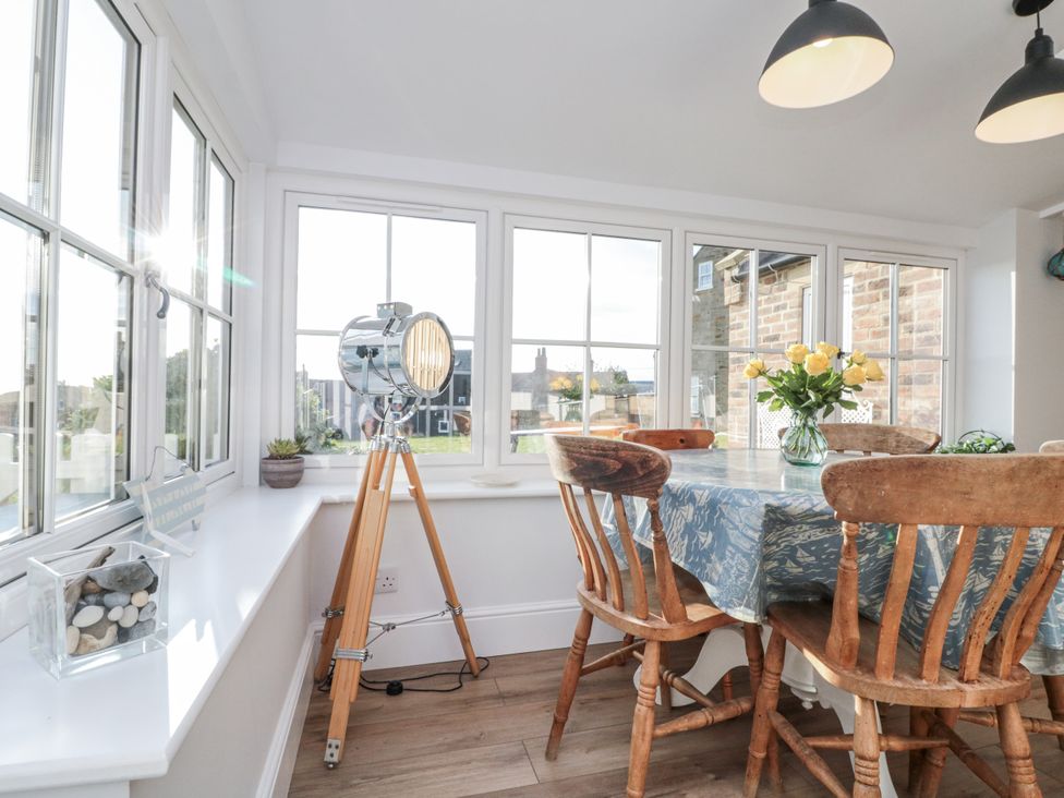 A dining room with a table and chairs at Croft View in Fylingthorpe near Robin Hood's Bay