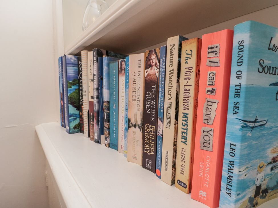 A bookshelf filled with various books at Croft View in Fylingthorpe near Robin Hood's Bay