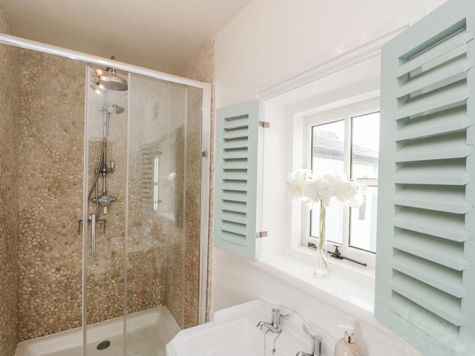 A bathroom with a shower and sink at Croft View in Fylingthorpe near Robin Hood's Bay