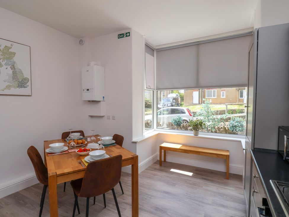 A kitchen with a table and chairs at 1 Roxby Terrace Thornton-le-Dale