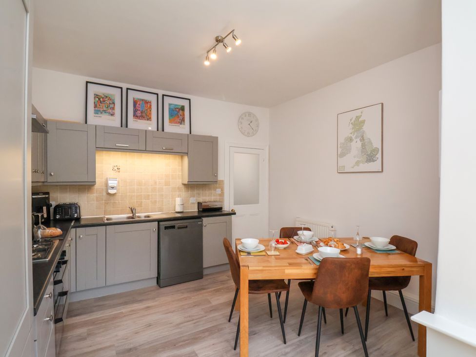 A kitchen with a dining table and chairs at 1 Roxby Terrace in Thornton-le-Dale