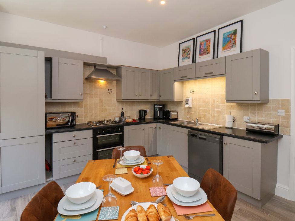 A kitchen with cabinets and appliances at 1 Roxby Terrace in Thornton-le-Dale