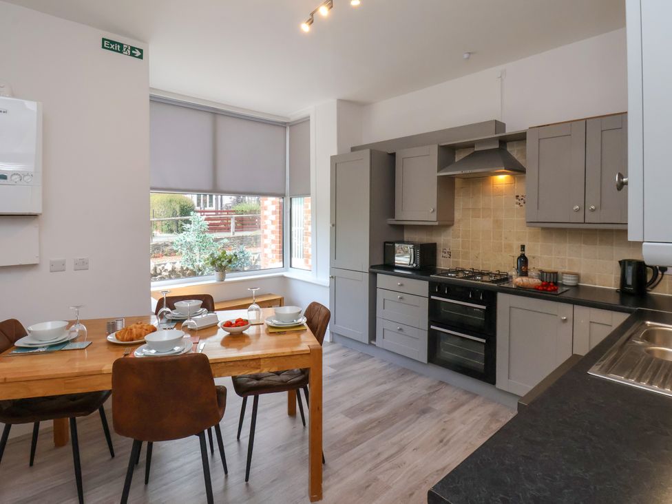 A kitchen with dining table and appliances at 1 Roxby Terrace in Thornton-le-Dale