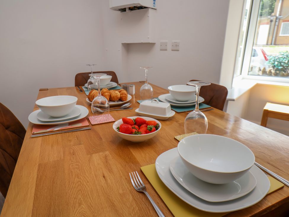 A dining table set with dishes and fruit at 1 Roxby Terrace in Thornton-le-Dale