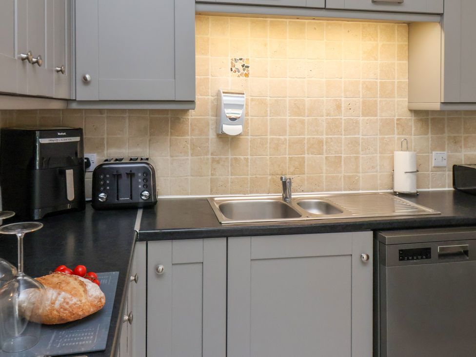 A kitchen with a sink, toaster, and dishwasher at 1 Roxby Terrace in Thornton-le-Dale