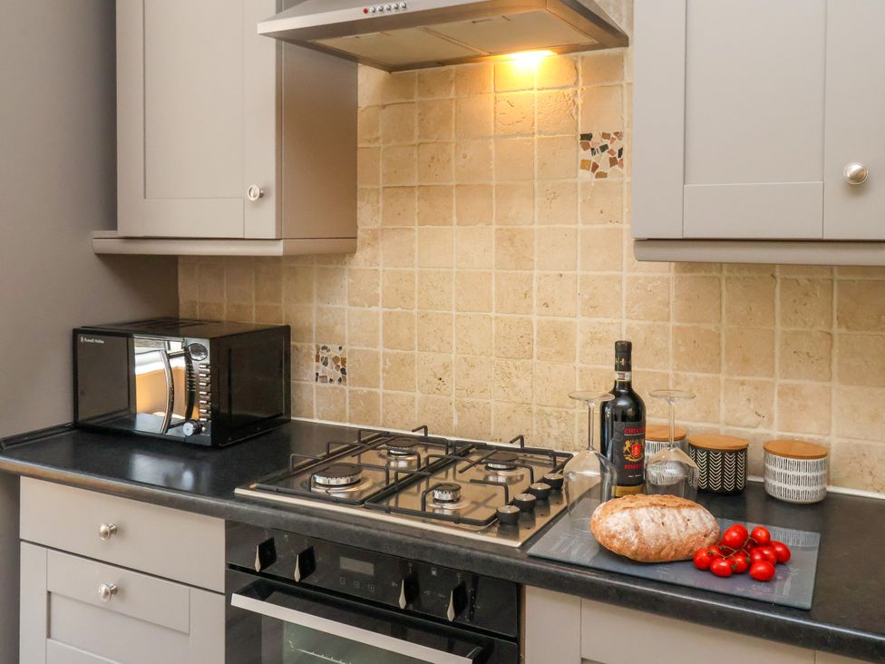A kitchen with a gas stove and bread on the counter at 1 Roxby Terrace Thornton-le-Dale