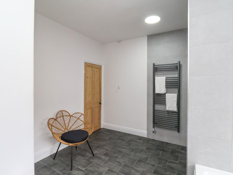 A bathroom with a chair and towel rail at 1 Roxby Terrace Thornton-le-Dale