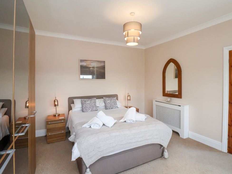 A bedroom with a bed and bedside tables at 1 Roxby Terrace in Thornton-le-Dale