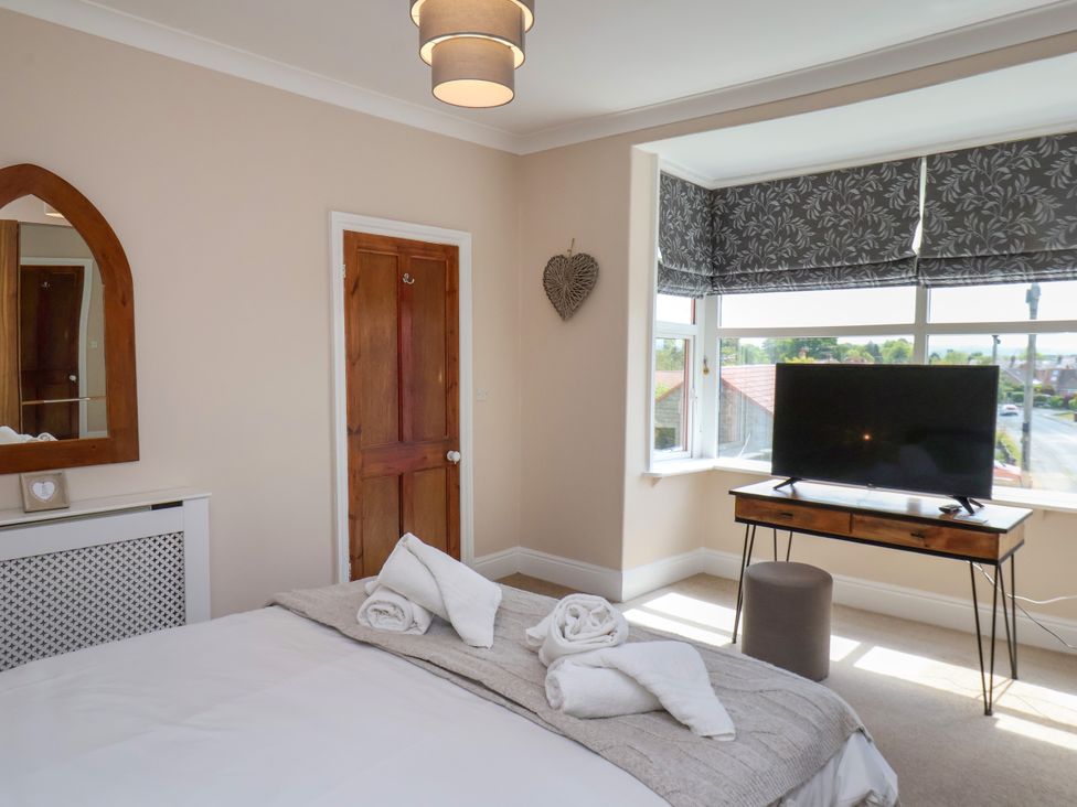 A bedroom with a bed and television at 1 Roxby Terrace Thornton-le-Dale