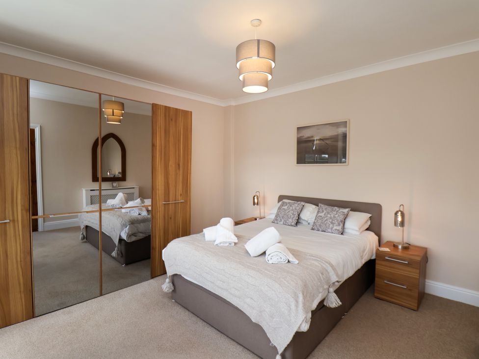 A bedroom with a bed and wardrobe at 1 Roxby Terrace in Thornton-le-Dale