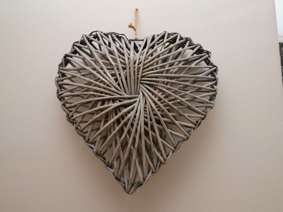 A wicker heart hanging on a wall at 1 Roxby Terrace in Thornton-le-Dale