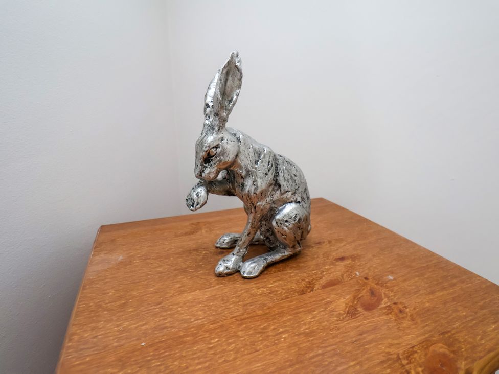 A rabbit sculpture on a wooden surface at 1 Roxby Terrace in Thornton-le-Dale