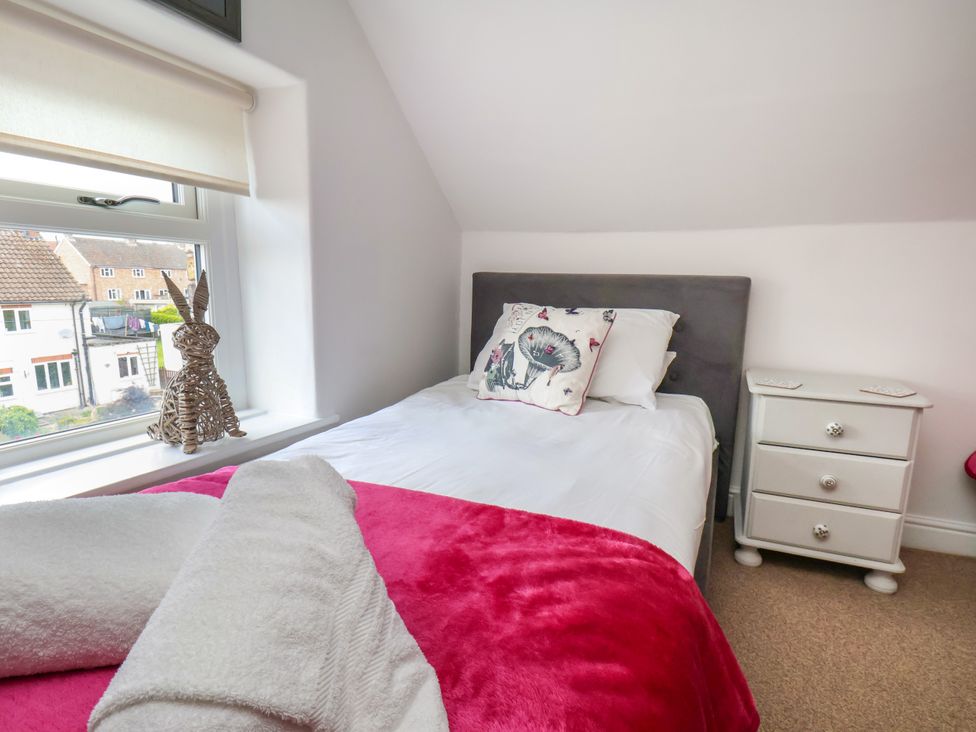 A bedroom with a bed and a nightstand at 1 Roxby Terrace Thornton-le-Dale