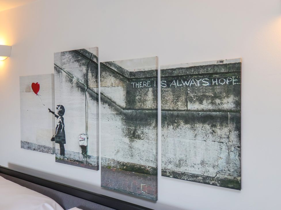 Wall art depicting a girl with a balloon and text at 1 Roxby Terrace in Thornton-le-Dale