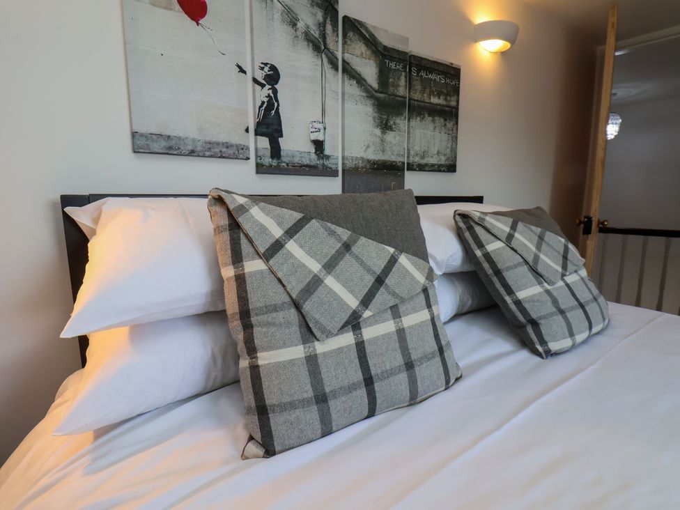 A bedroom with a bed and pillows at 1 Roxby Terrace, Thornton-le-Dale