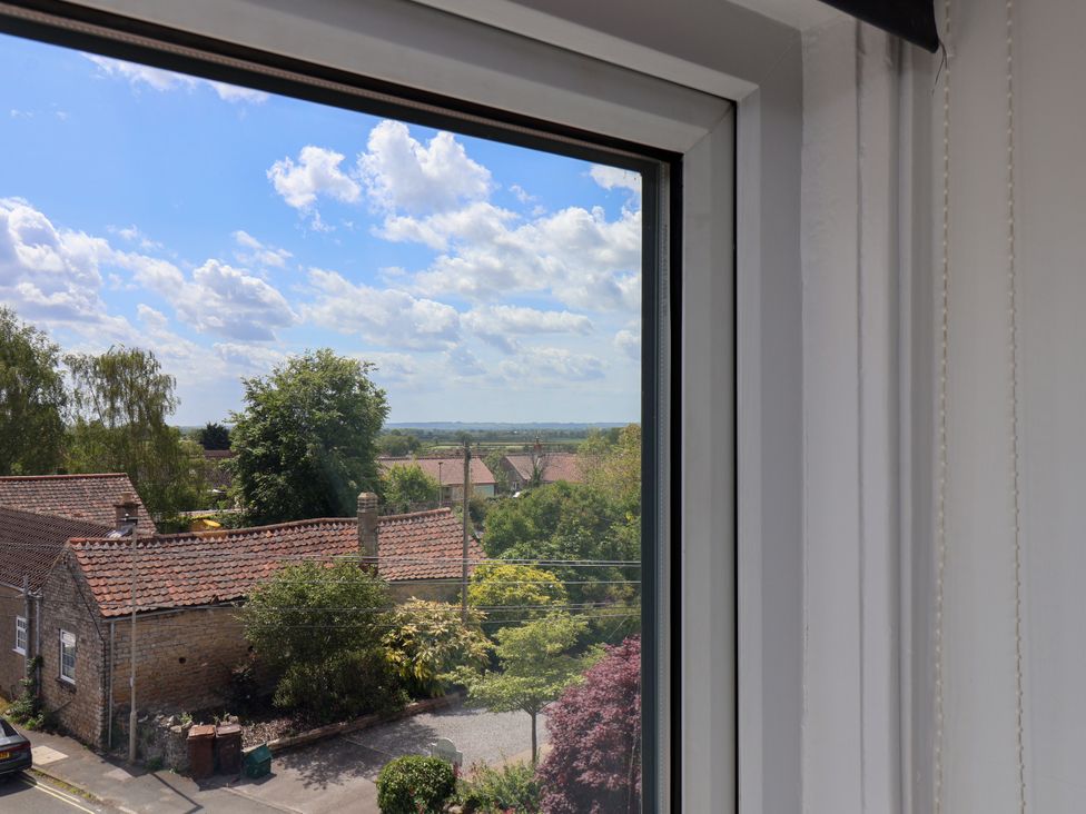 A view from a window showing houses and trees at 1 Roxby Terrace in Thornton-le-Dale