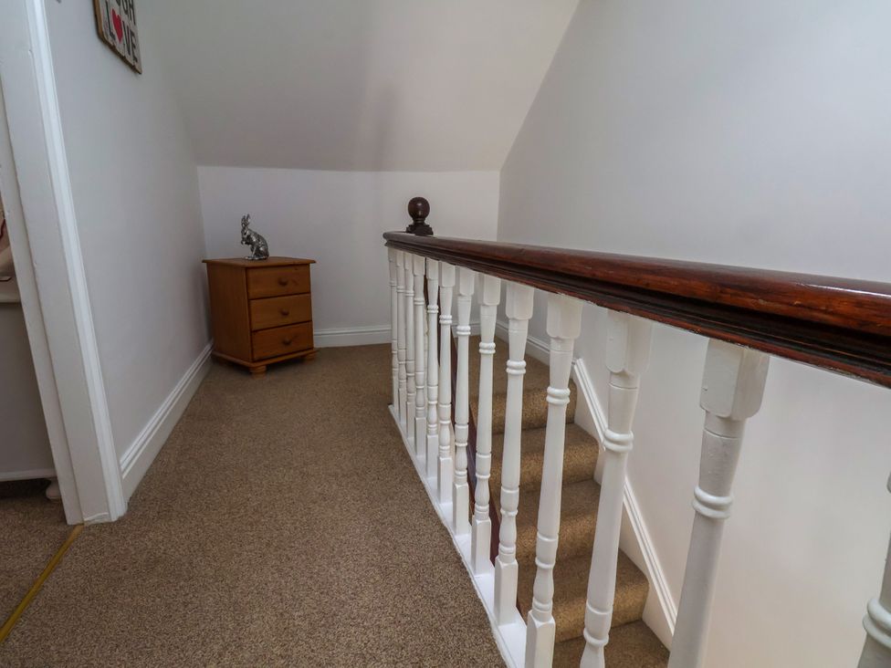 A landing area with a staircase and a chest of drawers at 1 Roxby Terrace in Thornton-le-Dale