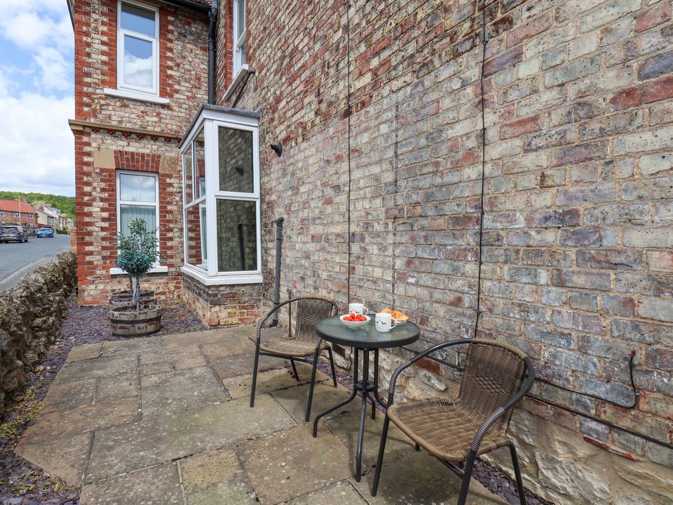 A patio area with a table and chairs at 1 Roxby Terrace Thornton-le-Dale