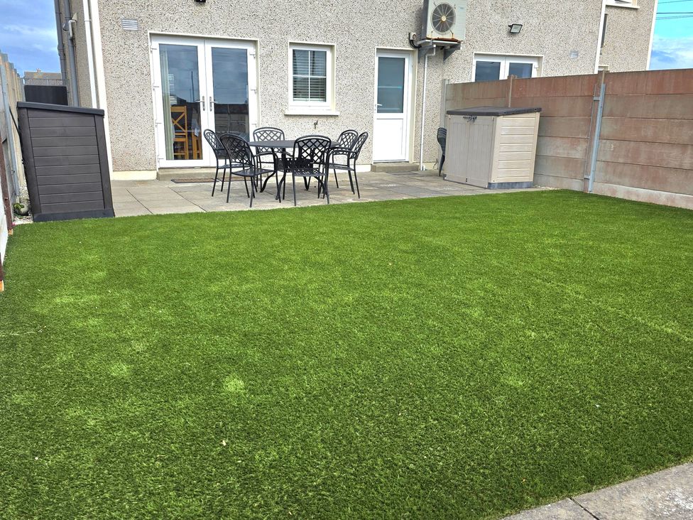 A garden with artificial grass and patio furniture at 63 Moinin, Kilkee, County Clare