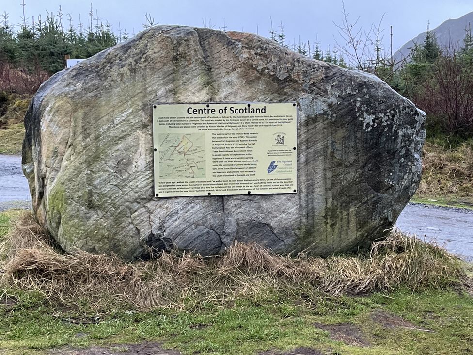 A large rock with an information panel at the Centre of Scotland