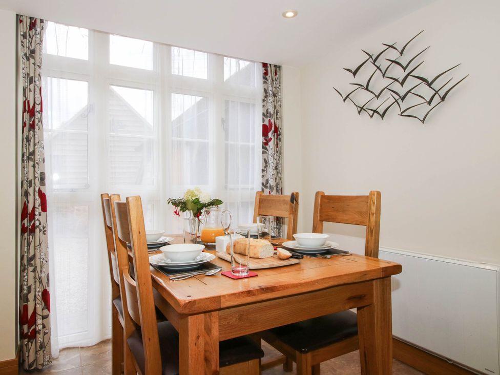 A dining room with a table and chairs at Swallows Cottage Harley near Much Wenlock