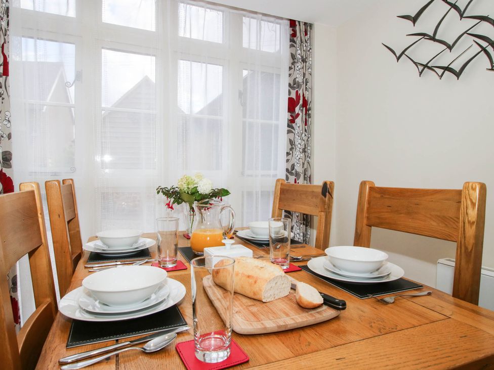 A dining room with a table set for a meal at Swallows Cottage Harley near Much Wenlock