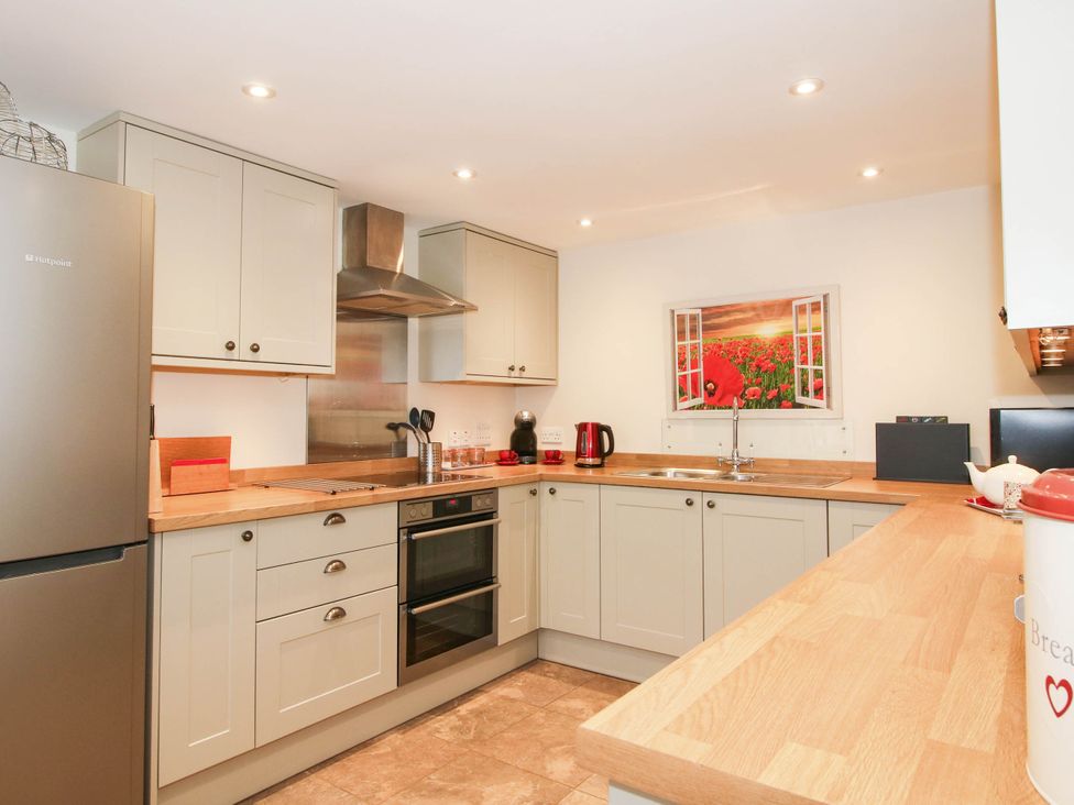 A kitchen with a fridge and oven at Swallows Cottage Harley near Much Wenlock