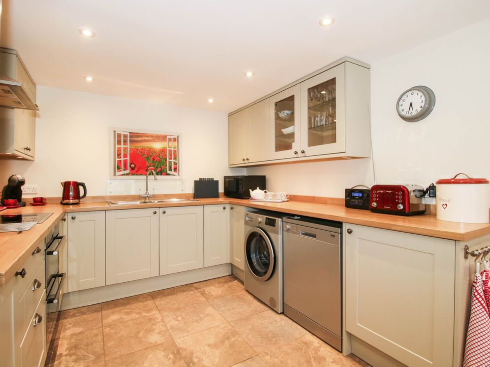 A kitchen with appliances and cabinetry at Swallows Cottage in Harley near Much Wenlock